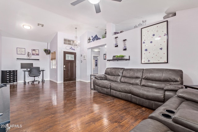 living room with ceiling fan with notable chandelier, dark hardwood / wood-style flooring, and high vaulted ceiling