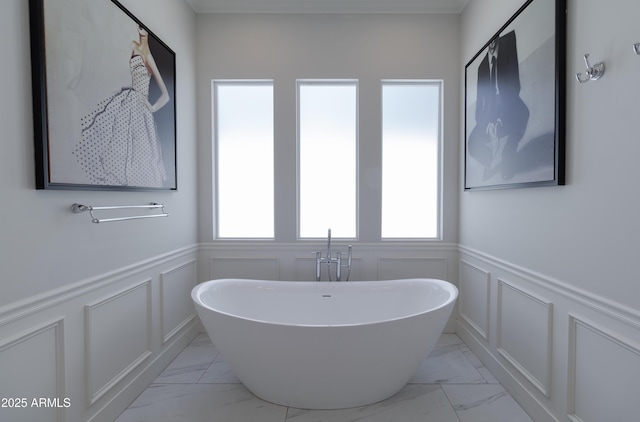 3813 N 37th St, Phoenix, AZ 85018 - full bath featuring marble finish floors, a decorative wall, plenty of natural light, a freestanding bath, and a wainscoted wall