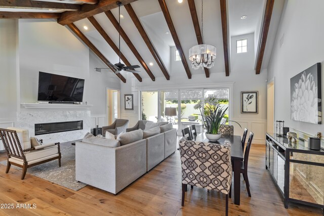 3813 N 37th St, Phoenix, AZ 85018 - living room featuring a decorative wall, beamed ceiling, a fireplace, high vaulted ceiling, and recessed lighting