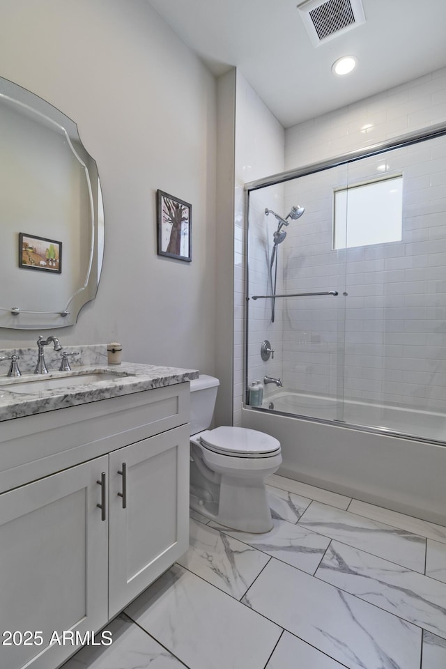 3813 N 37th St, Phoenix, AZ 85018 - bathroom featuring vanity, toilet, shower / bath combination with glass door, and marble finish floors