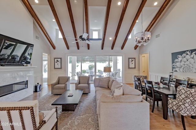 3813 N 37th St, Phoenix, AZ 85018 - living area featuring a decorative wall, a high end fireplace, recessed lighting, beamed ceiling, and wood finished floors