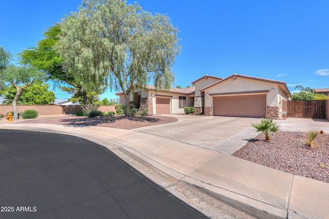 2514 E Grand Canyon Dr, Chandler, AZ 85249 - view of front of house with a garage, stucco siding, stone siding, concrete driveway, and a tile roof