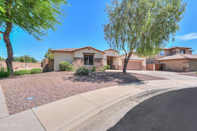 2514 E Grand Canyon Dr, Chandler, AZ 85249 - mediterranean / spanish house featuring stucco siding, stone siding, concrete driveway, a tile roof, and a gate
