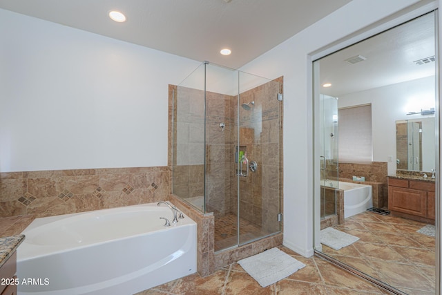 2514 E Grand Canyon Dr, Chandler, AZ 85249 - bathroom with vanity, a garden tub, a stall shower, and recessed lighting