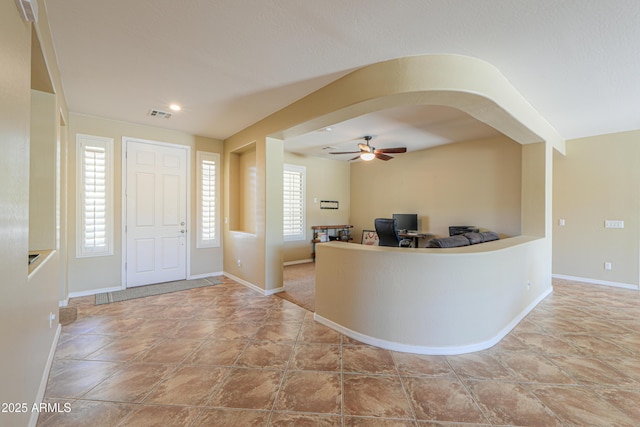 2514 E Grand Canyon Dr, Chandler, AZ 85249 - entryway featuring ceiling fan, stone finish floors, and arched walkways
