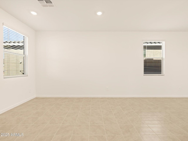 spare room featuring light tile patterned floors