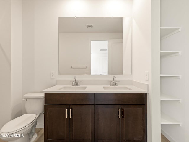 bathroom featuring toilet and vanity