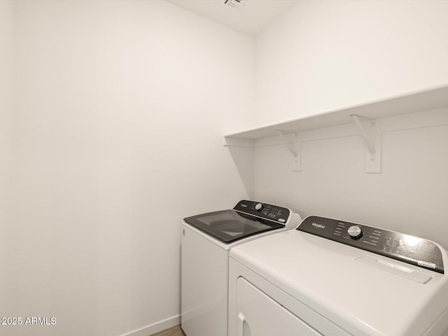 laundry room with washing machine and clothes dryer