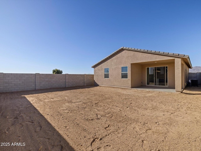 rear view of house featuring central AC unit and a patio