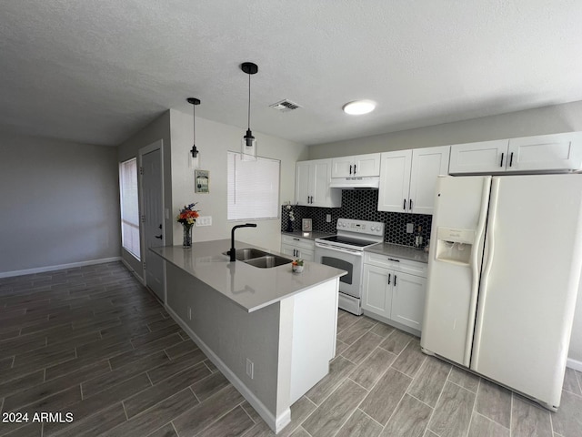 kitchen featuring white refrigerator with ice dispenser, white cabinets, sink, range with electric stovetop, and kitchen peninsula