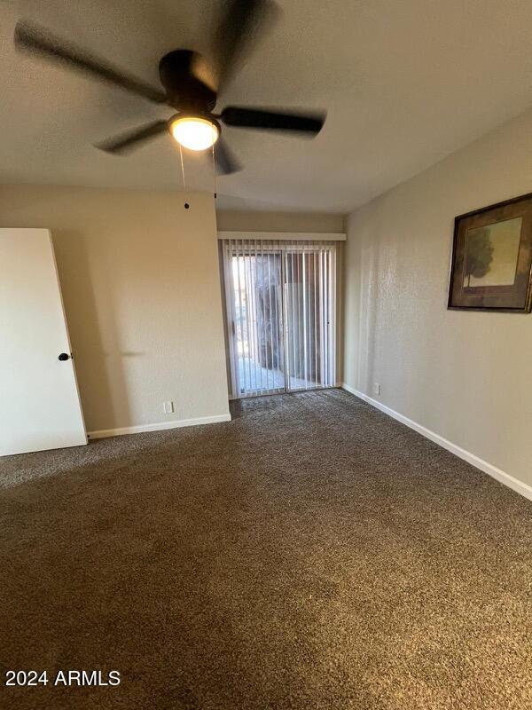 unfurnished room featuring carpet flooring and ceiling fan