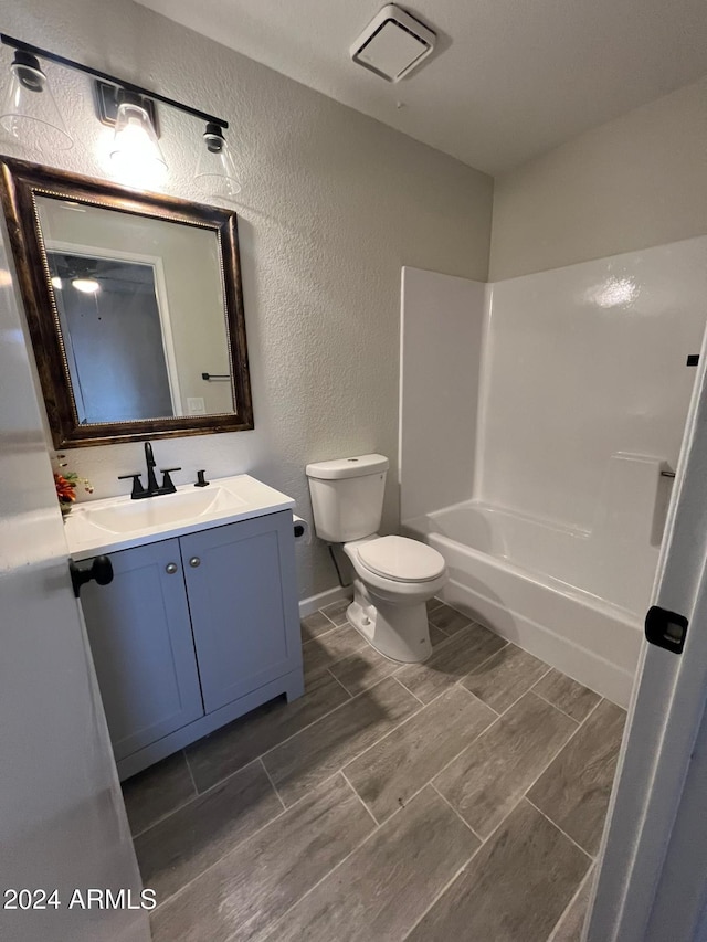 full bathroom featuring vanity, toilet, and shower / tub combination