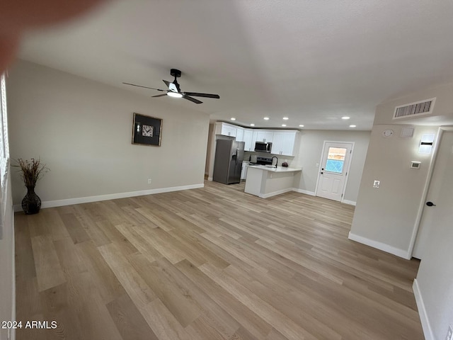 unfurnished living room with ceiling fan and light wood-type flooring