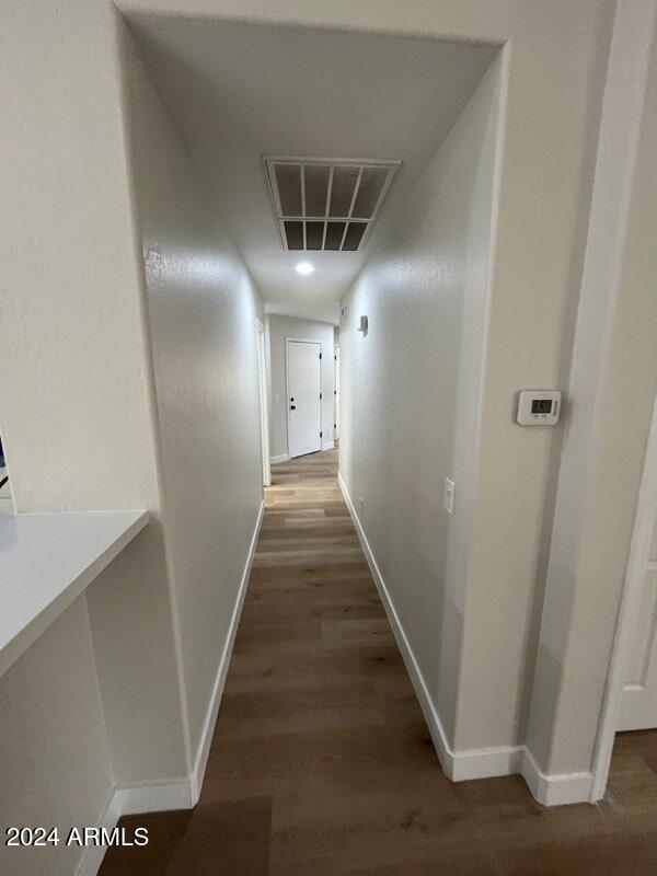 hallway with dark hardwood / wood-style floors