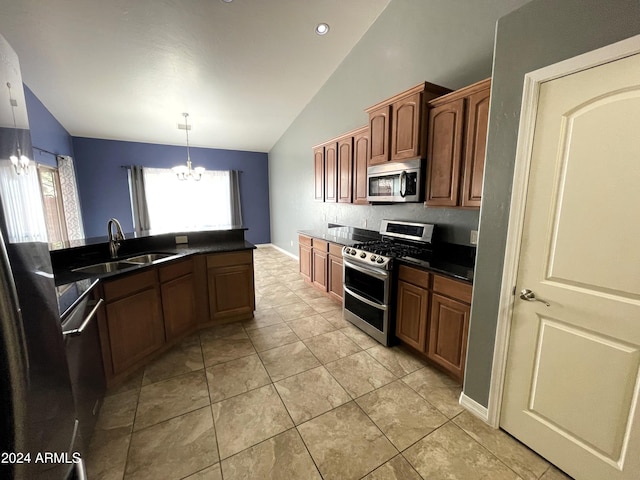 kitchen with lofted ceiling, sink, appliances with stainless steel finishes, hanging light fixtures, and a notable chandelier