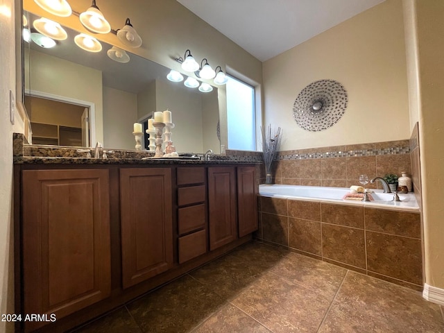 bathroom featuring a relaxing tiled tub and vanity