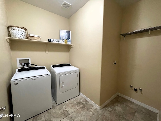 washroom featuring washer and clothes dryer