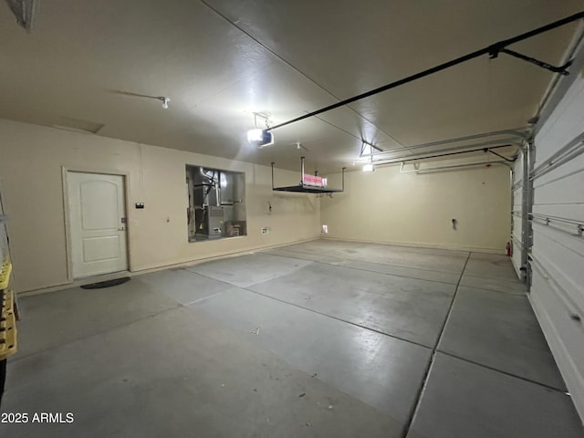 garage featuring a garage door opener and heating unit