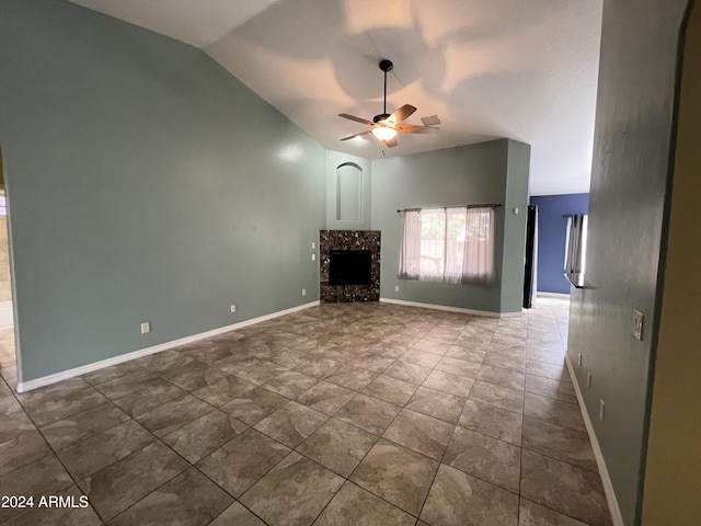 unfurnished living room featuring lofted ceiling, a tile fireplace, and ceiling fan