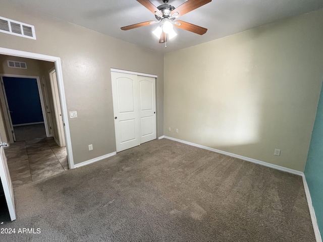 unfurnished bedroom featuring a closet, ceiling fan, and dark colored carpet