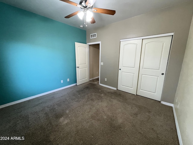 unfurnished bedroom featuring a closet, ceiling fan, and dark colored carpet