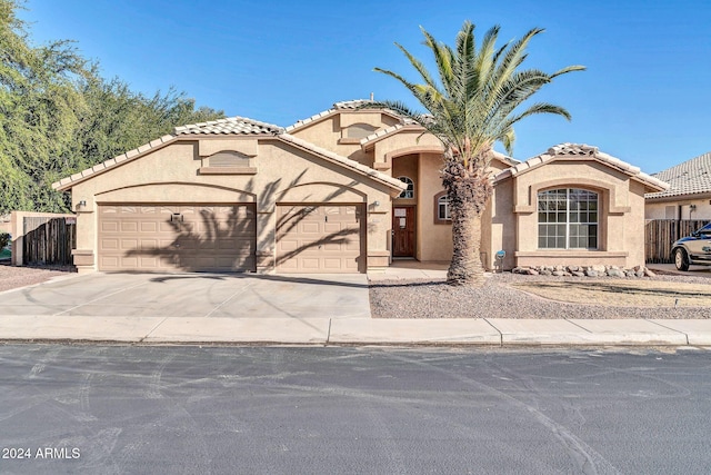 mediterranean / spanish home featuring a garage