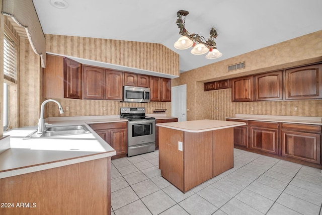 kitchen with stainless steel appliances, lofted ceiling, sink, light tile patterned floors, and a kitchen island