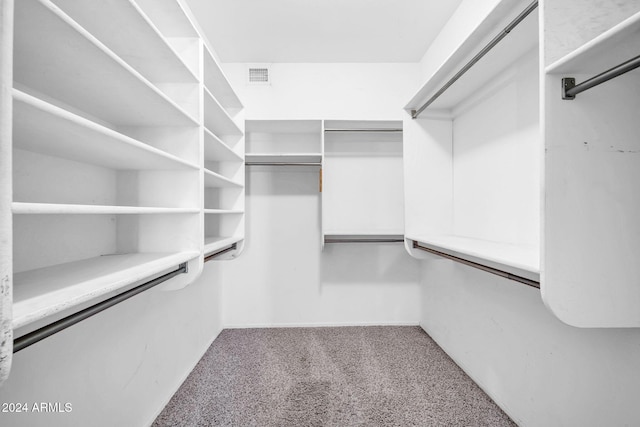 walk in closet with carpet flooring