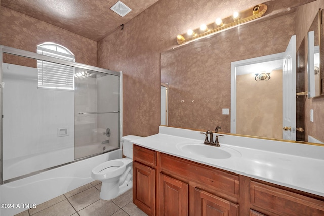 full bathroom featuring toilet, shower / bath combination with glass door, tile patterned floors, and vanity