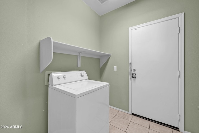 laundry room with light tile patterned floors and washer / clothes dryer