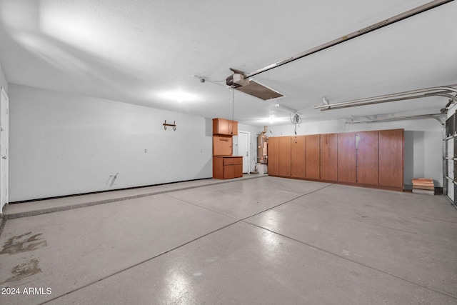 garage featuring water heater and a garage door opener