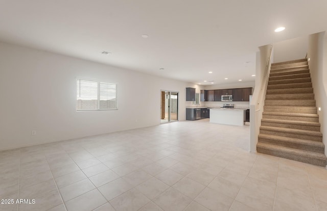 unfurnished living room with visible vents, recessed lighting, stairs, and light tile patterned flooring