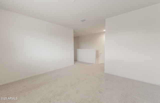 spare room featuring recessed lighting, carpet floors, visible vents, and baseboards