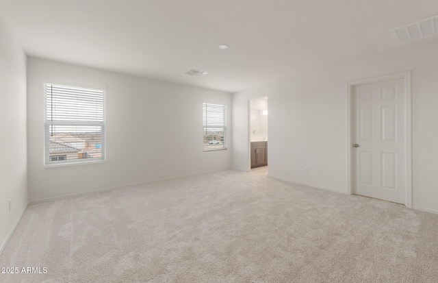 unfurnished room with light carpet, baseboards, and visible vents