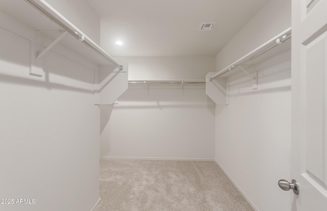 spacious closet featuring carpet flooring and visible vents