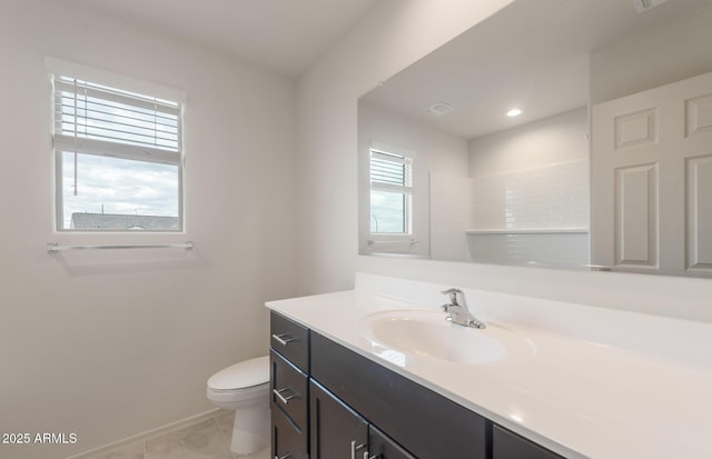 bathroom with baseboards, toilet, vanity, and tile patterned floors