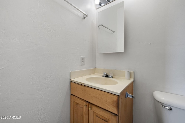 half bath featuring toilet and vanity