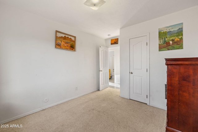 unfurnished bedroom with carpet and baseboards