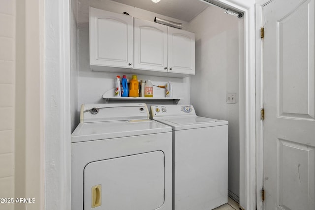 laundry area featuring independent washer and dryer and cabinet space