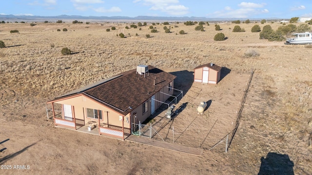 bird's eye view featuring view of desert and a rural view