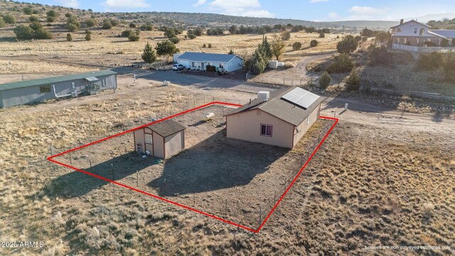 birds eye view of property featuring view of desert and a rural view