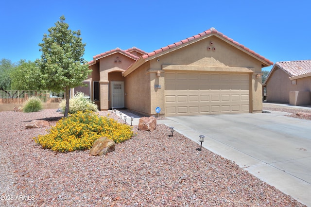 103 S Birdie Way, Casa Grande, AZ 85194 - mediterranean / spanish house featuring stucco siding, a tile roof, concrete driveway, and an attached garage