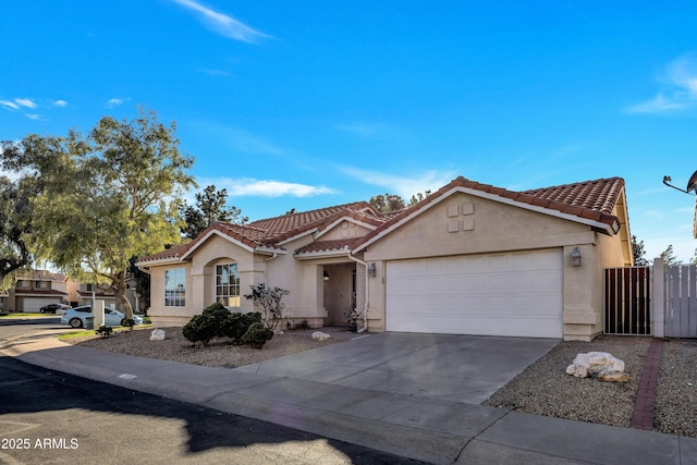 view of front facade featuring a garage, concrete driveway, a tile roof, and stucco siding