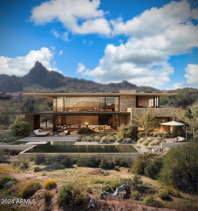 exterior space with a mountain view and a patio area