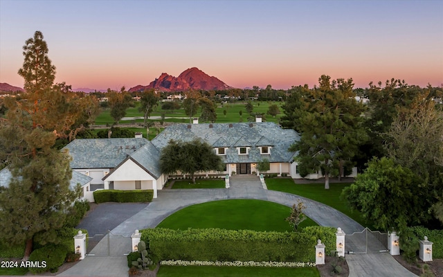 view of front of house featuring a mountain view and a yard