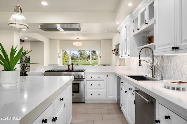 kitchen with exhaust hood, sink, decorative light fixtures, white cabinetry, and stainless steel appliances