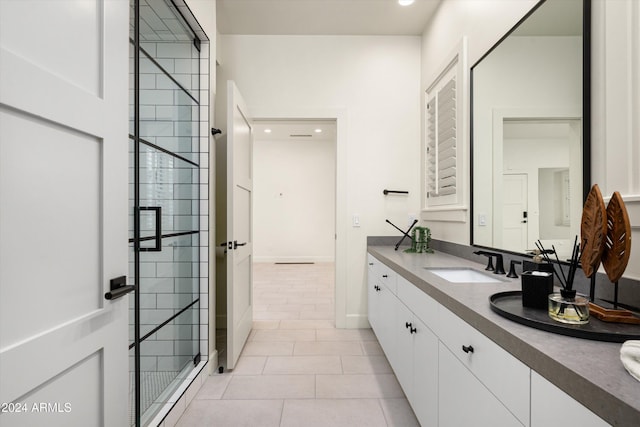 bathroom with tile patterned flooring, vanity, and a shower with shower door