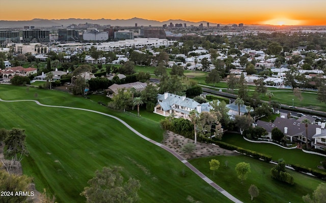 aerial view at dusk featuring a mountain view