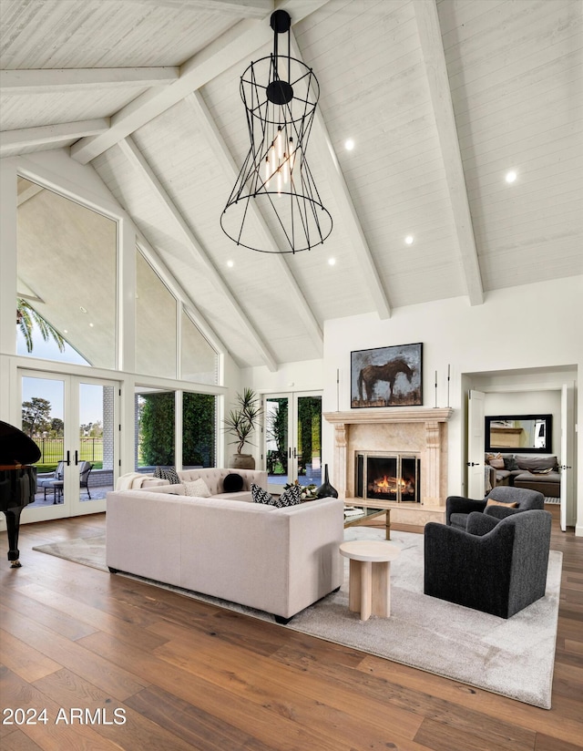 living room featuring hardwood / wood-style flooring, beam ceiling, high vaulted ceiling, and french doors