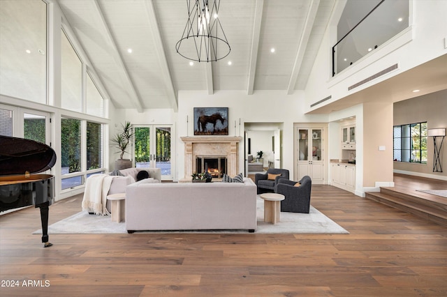 living room featuring french doors, high vaulted ceiling, and wood-type flooring